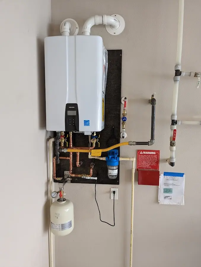 Professional plumber installing copper piping in a Belen home